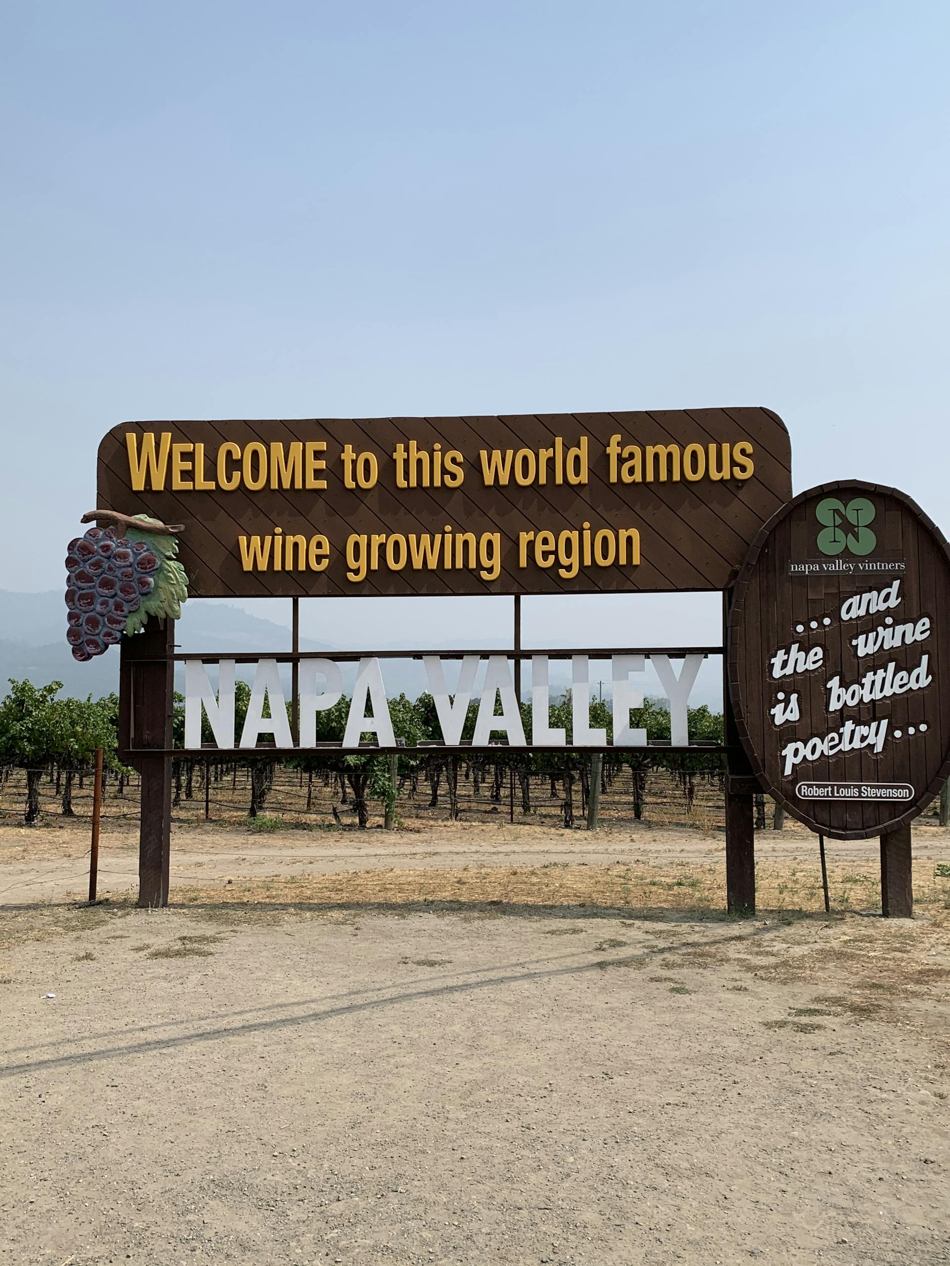 Welcome sign in Napa Valley amidst vineyards, famous wine region.